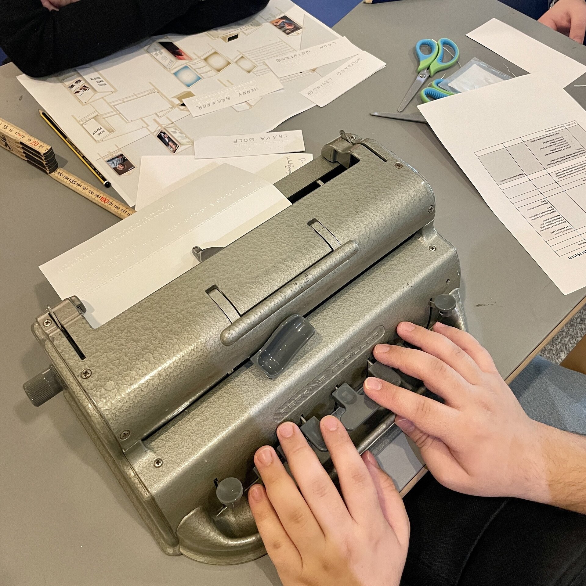 Hände liegen auf einer Schreibmaschine.